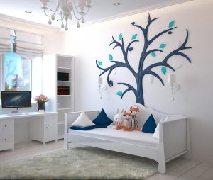 A stylish childrens room with a modern design featuring a tree wall art and plush toys.